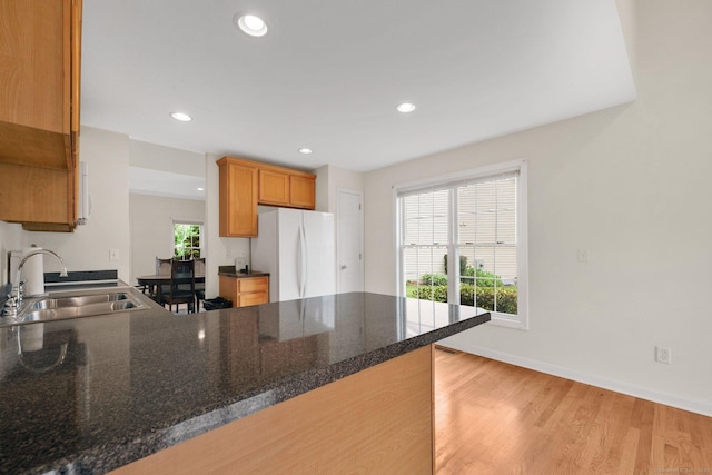 6 Mountainview Cir Unit 6, Ellington, CT 06029 - kitchen with freestanding refrigerator, a peninsula, light wood finished floors, recessed lighting, and dark stone counters