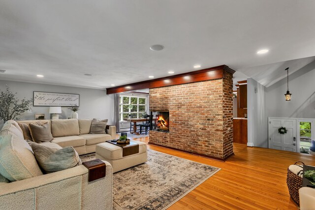 24 Buttonball Ln, Glastonbury, CT 06033 - living room featuring wood finished floors, a brick fireplace, and recessed lighting