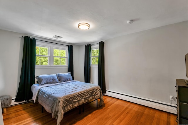 24 Buttonball Ln, Glastonbury, CT 06033 - bedroom featuring baseboard heating and wood finished floors