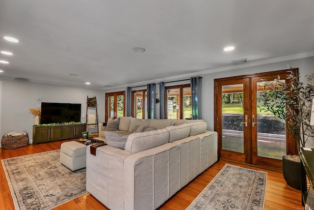 24 Buttonball Ln, Glastonbury, CT 06033 - living room with ornamental molding, healthy amount of natural light, wood finished floors, recessed lighting, and french doors