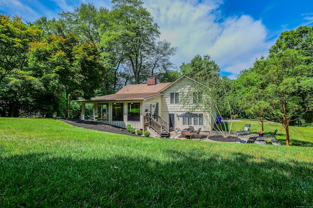 24 Buttonball Ln, Glastonbury, CT 06033 - rear view of house featuring a lawn and a chimney