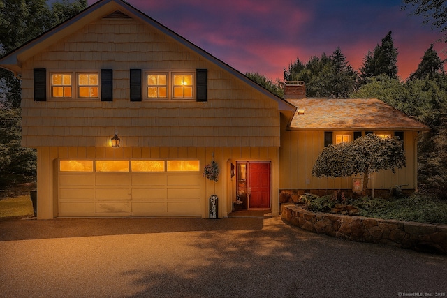 24 Buttonball Ln, Glastonbury, CT 06033 - chalet / cabin with a chimney, driveway, board and batten siding, and an attached garage