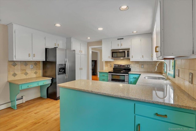 53 Montclair Dr, Manchester, CT 06042 - kitchen with appliances with stainless steel finishes, decorative backsplash, light wood-style floors, a peninsula, and white cabinets