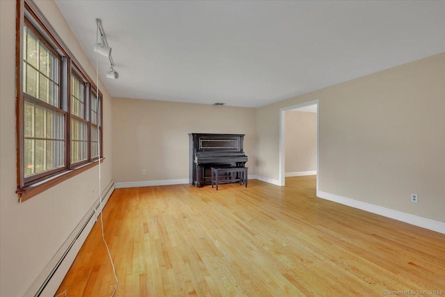 53 Montclair Dr, Manchester, CT 06042 - unfurnished living room featuring baseboard heating, wood finished floors, and rail lighting