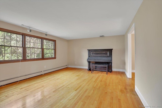 53 Montclair Dr, Manchester, CT 06042 - unfurnished living room with wood finished floors, a baseboard radiator, and track lighting