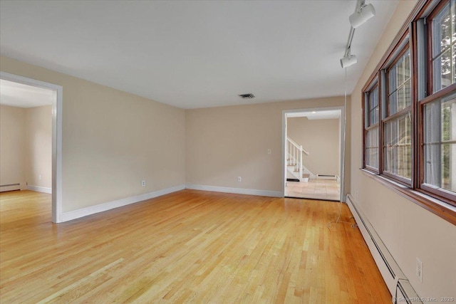 53 Montclair Dr, Manchester, CT 06042 - empty room featuring light wood-type flooring, stairway, a baseboard radiator, and rail lighting