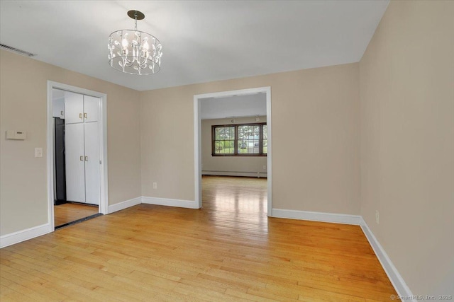 53 Montclair Dr, Manchester, CT 06042 - spare room featuring a chandelier, light wood-type flooring, and a baseboard heating unit
