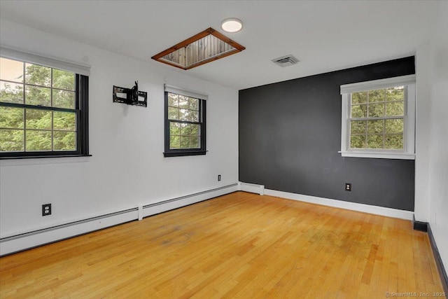 53 Montclair Dr, Manchester, CT 06042 - empty room featuring a baseboard radiator, healthy amount of natural light, and wood finished floors