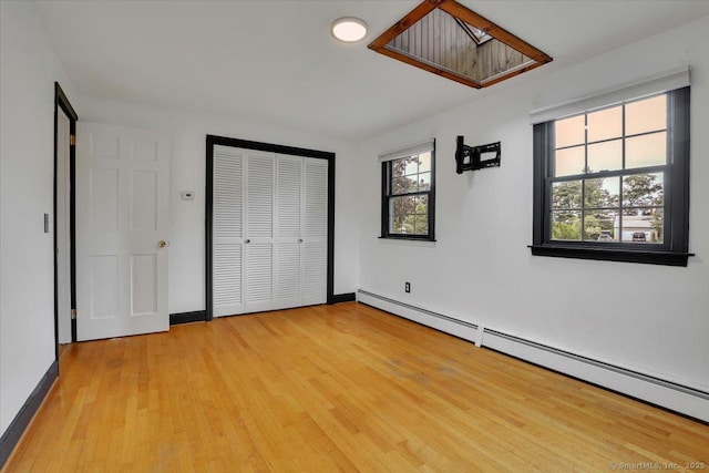 53 Montclair Dr, Manchester, CT 06042 - unfurnished bedroom featuring a baseboard radiator, light wood finished floors, and a closet