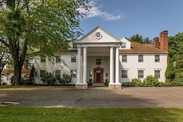 view of front of house featuring a chimney