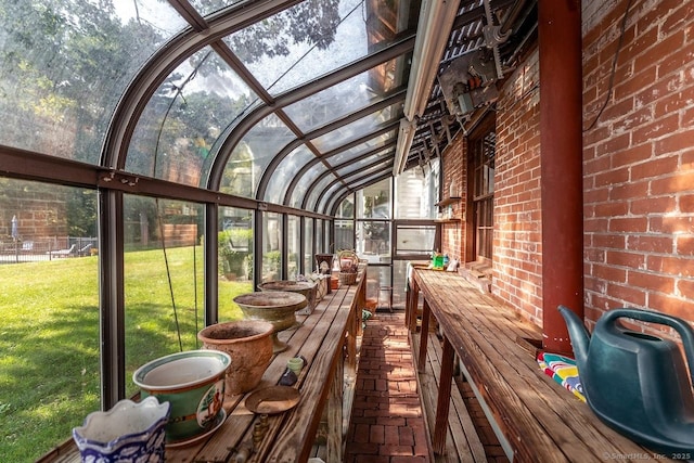sunroom / solarium featuring vaulted ceiling