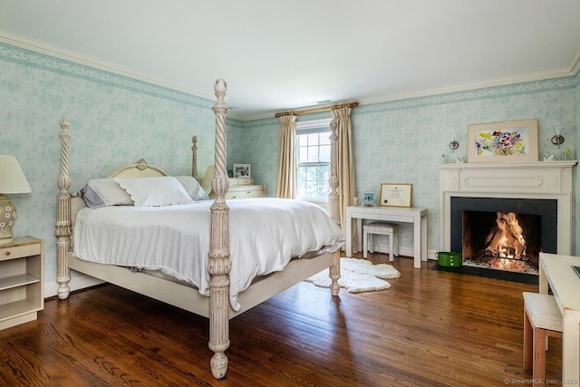 bedroom featuring wallpapered walls, wood finished floors, a warm lit fireplace, and ornamental molding