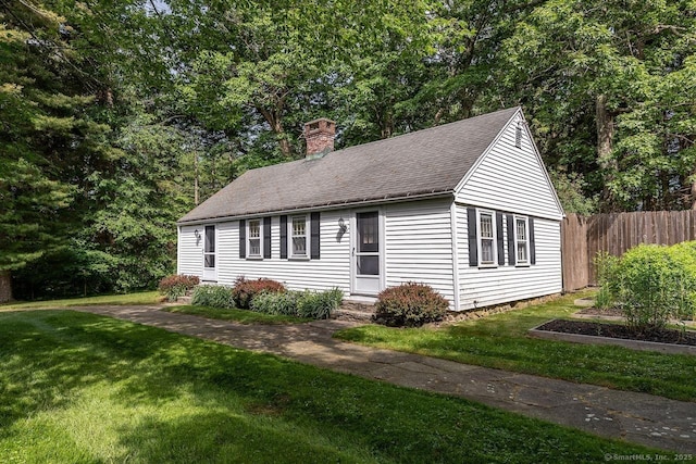 view of front of house with a chimney and roof with shingles