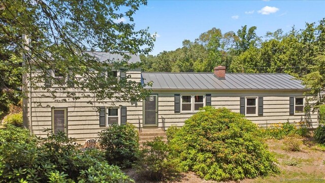 45 Canton Rd, Granby, CT 06035 - view of front facade with a chimney, a standing seam roof, and a metal roof
