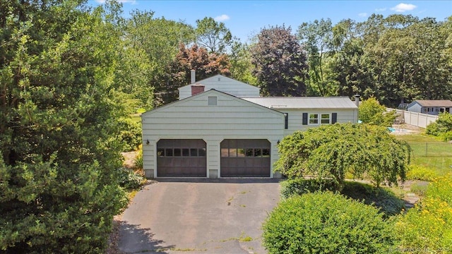 45 Canton Rd, Granby, CT 06035 - view of front of property featuring asphalt driveway, a garage, and a chimney