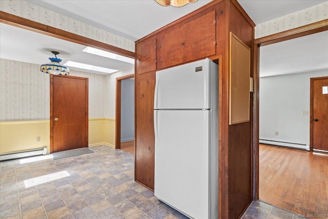 45 Canton Rd, Granby, CT 06035 - kitchen with freestanding refrigerator, wallpapered walls, a baseboard radiator, and brown cabinetry