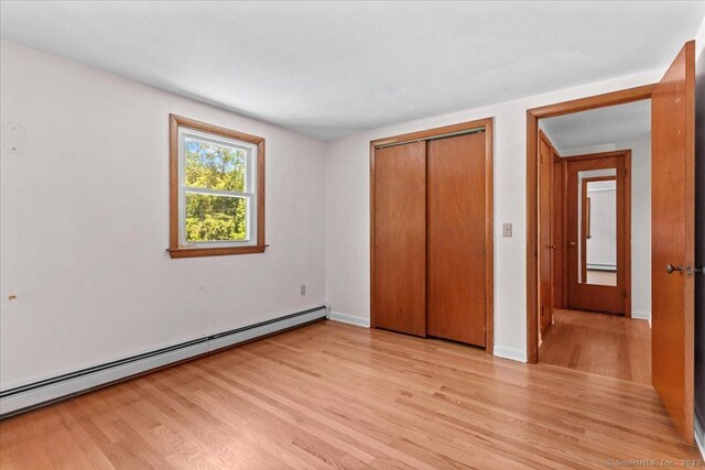 45 Canton Rd, Granby, CT 06035 - unfurnished bedroom featuring baseboard heating, light wood-style floors, and a closet