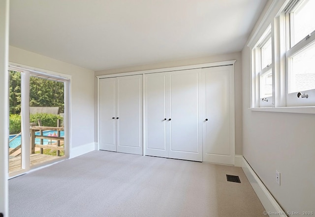 45 Canton Rd, Granby, CT 06035 - unfurnished bedroom with light carpet, access to exterior, and a closet