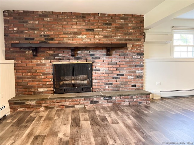 159 Radnor Ln, Watertown, CT 06779 - detailed view of a baseboard heating unit, wood finished floors, a wall mounted air conditioner, and a fireplace
