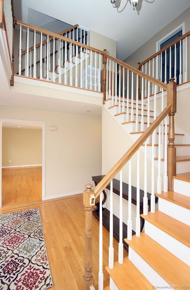 29 Quarry Ln, Hamden, CT 06518 - stairs with wood finished floors, a high ceiling, and a chandelier