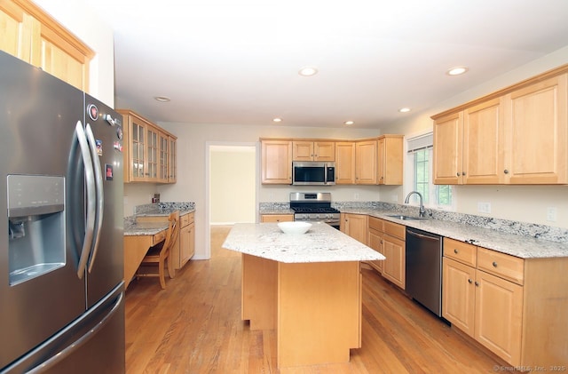 29 Quarry Ln, Hamden, CT 06518 - kitchen featuring stainless steel appliances, light brown cabinets, a kitchen island, light wood-style floors, and glass insert cabinets