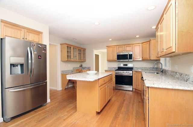 29 Quarry Ln, Hamden, CT 06518 - kitchen with appliances with stainless steel finishes, light wood finished floors, recessed lighting, a kitchen island, and light stone countertops
