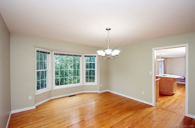 29 Quarry Ln, Hamden, CT 06518 - spare room featuring a chandelier and light wood-type flooring
