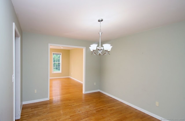 29 Quarry Ln, Hamden, CT 06518 - spare room featuring a chandelier and light wood-style floors