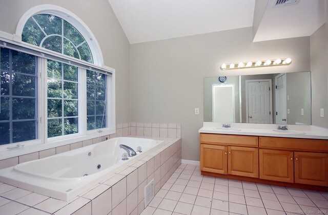 29 Quarry Ln, Hamden, CT 06518 - full bathroom featuring lofted ceiling, double vanity, a whirlpool tub, and tile patterned floors