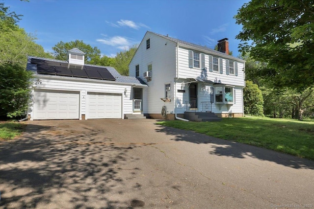 80 Bread And Milk St, Coventry, CT 06238 - colonial home with a chimney, driveway, solar panels, a garage, and a front lawn