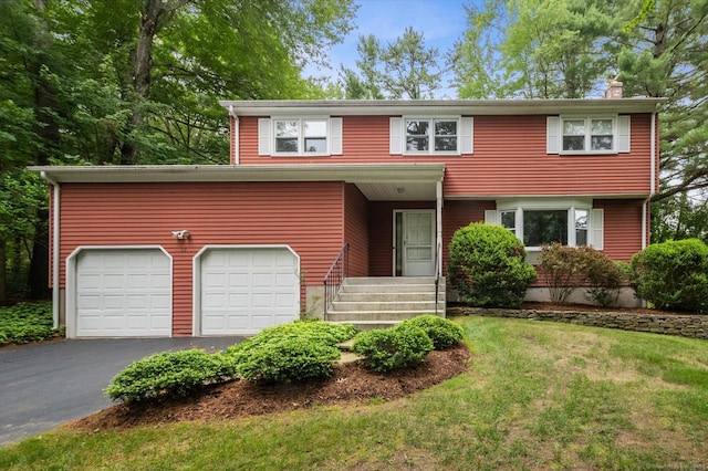 18 Banks Rd, Simsbury, CT 06070 - view of front facade with driveway, a chimney, a front yard, and an attached garage