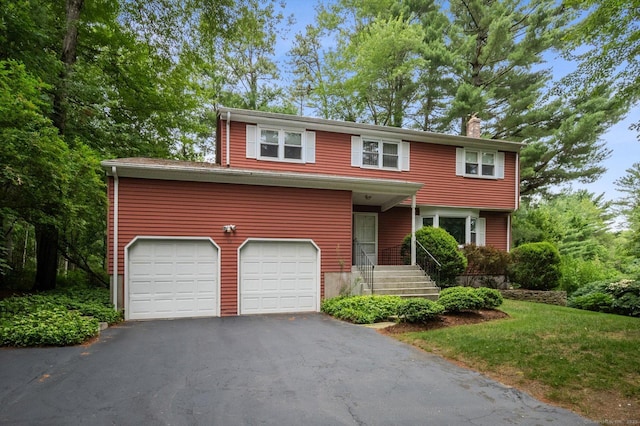 18 Banks Rd, Simsbury, CT 06070 - view of front facade with a chimney, driveway, and an attached garage