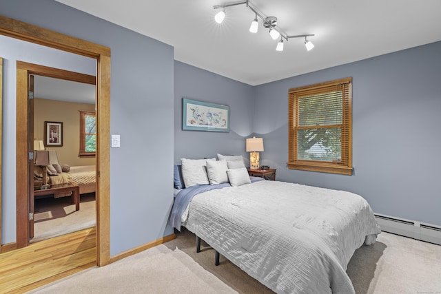 34 Joyce St, Guilford, CT 06437 - carpeted bedroom featuring a baseboard radiator and rail lighting