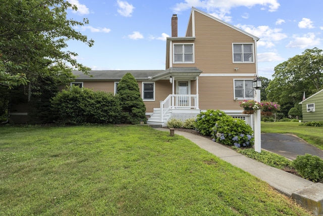 34 Joyce St, Guilford, CT 06437 - view of front of home with a chimney, a front yard, a garage, and driveway