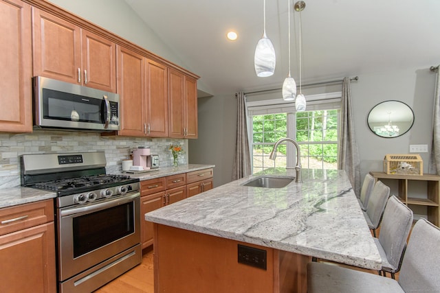 40 Airport Rd, Killingly, CT 06239 - kitchen with appliances with stainless steel finishes, light stone countertops, tasteful backsplash, a kitchen bar, and brown cabinets