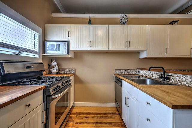 53 Canner St Apt 2, New Haven, CT 06511 - kitchen featuring stainless steel appliances, wooden counters, light wood-type flooring, ornamental molding, and white cabinetry