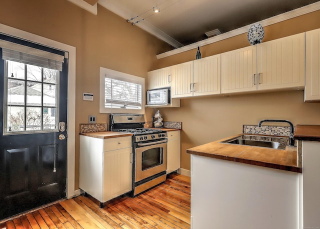 53 Canner St Apt 2, New Haven, CT 06511 - kitchen featuring stainless steel appliances, ornamental molding, butcher block counters, light wood-style flooring, and track lighting