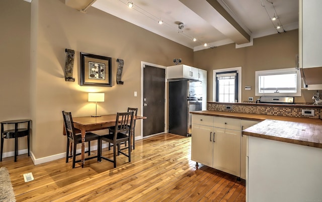 53 Canner St Apt 2, New Haven, CT 06511 - kitchen with rail lighting, white cabinetry, light wood-type flooring, a peninsula, and beamed ceiling