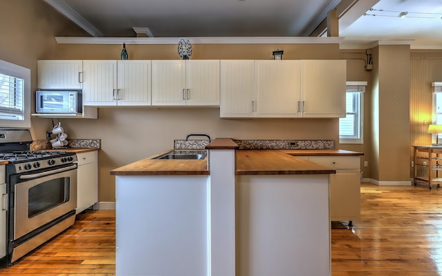 53 Canner St Apt 2, New Haven, CT 06511 - kitchen with butcher block countertops, gas stove, light wood-style flooring, crown molding, and healthy amount of natural light
