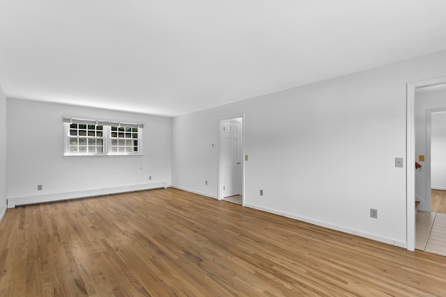 210 Carroll Rd, Fairfield, CT 06824 - spare room with baseboard heating and wood finished floors