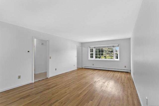 210 Carroll Rd, Fairfield, CT 06824 - empty room with baseboard heating and wood finished floors