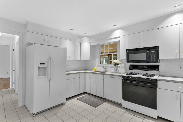 210 Carroll Rd, Fairfield, CT 06824 - kitchen with white appliances, light countertops, white cabinets, tasteful backsplash, and light tile patterned flooring