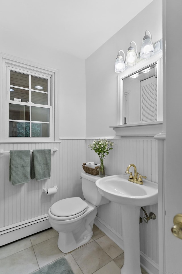 210 Carroll Rd, Fairfield, CT 06824 - bathroom featuring a baseboard radiator, a wainscoted wall, and tile patterned floors