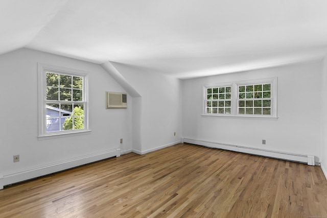 210 Carroll Rd, Fairfield, CT 06824 - additional living space featuring a baseboard heating unit, baseboard heating, wood finished floors, a wall unit AC, and lofted ceiling