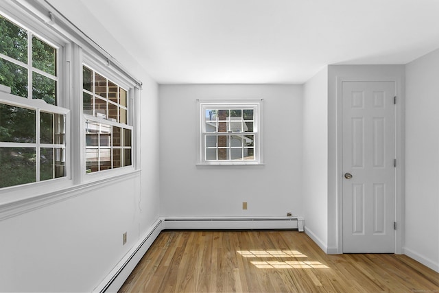 210 Carroll Rd, Fairfield, CT 06824 - unfurnished room with a baseboard radiator, wood finished floors, and baseboard heating