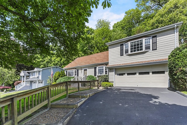 210 Carroll Rd, Fairfield, CT 06824 - tri-level home featuring asphalt driveway and a garage
