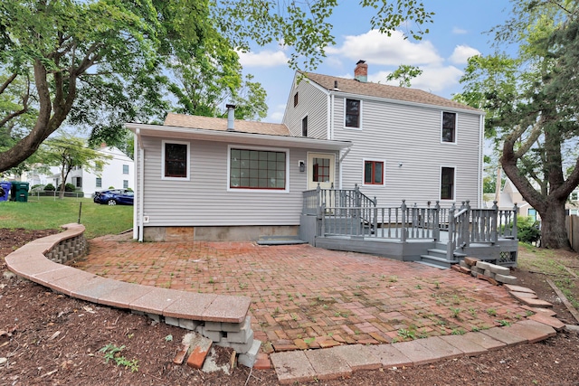162 Sheppard St, Stratford, CT 06614 - rear view of house with a patio, a chimney, a shingled roof, and a wooden deck