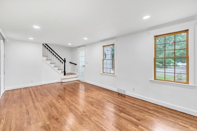162 Sheppard St, Stratford, CT 06614 - unfurnished living room featuring stairway, recessed lighting, light wood-style flooring, and healthy amount of natural light