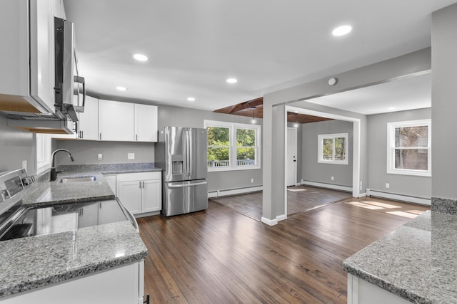 36 Greenfield St, Windsor, CT 06095 - kitchen with appliances with stainless steel finishes, a baseboard radiator, light stone counters, and recessed lighting