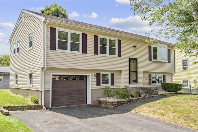 83 Julia Ter, Middletown, CT 06457 - raised ranch with an attached garage, a front lawn, and asphalt driveway